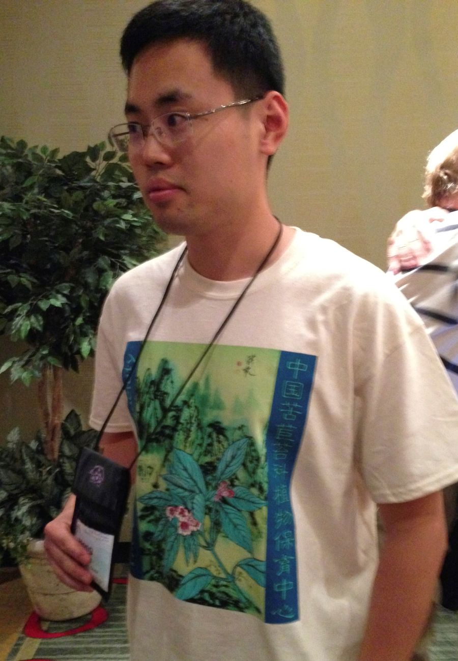 Hong Xin wearing the Society’s new tee-shirt he helped design featuring <i>Hemiboea roseoalba</i>