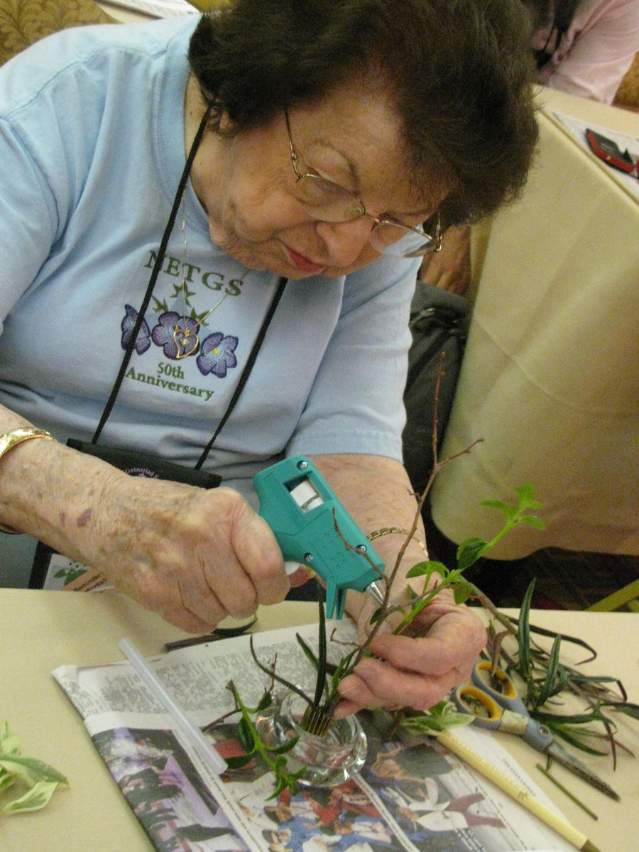 Mary Bozoian using a glue-gun to hold her design in place