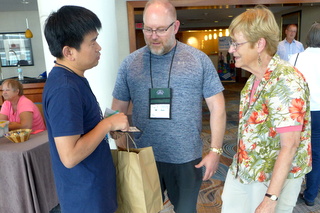 Greeting old friends and new at Registration: Qiu Zhi-Jing, Winston Goretsky, and Betsy Gottshall